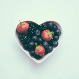 Summer berries in a heart-shaped bowl